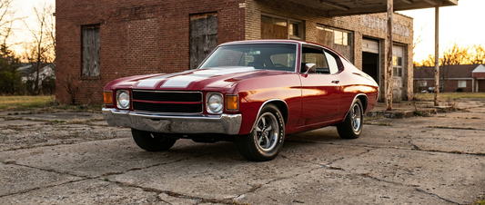 Red 1971 Chevelle SS with a cowl induction hood outside an old speed shop