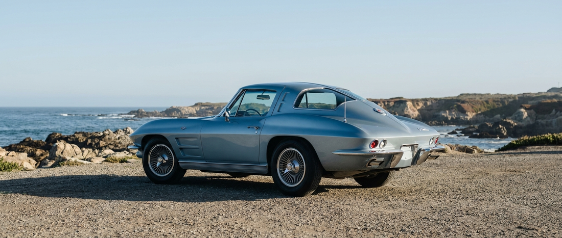 1963 Corvette Sting Ray split-window coupe parked at a coastal overlook