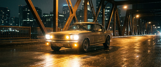 American muscle car crossing a city bridge at night