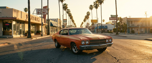 Classic American muscle car on a sunny palm-lined boulevard