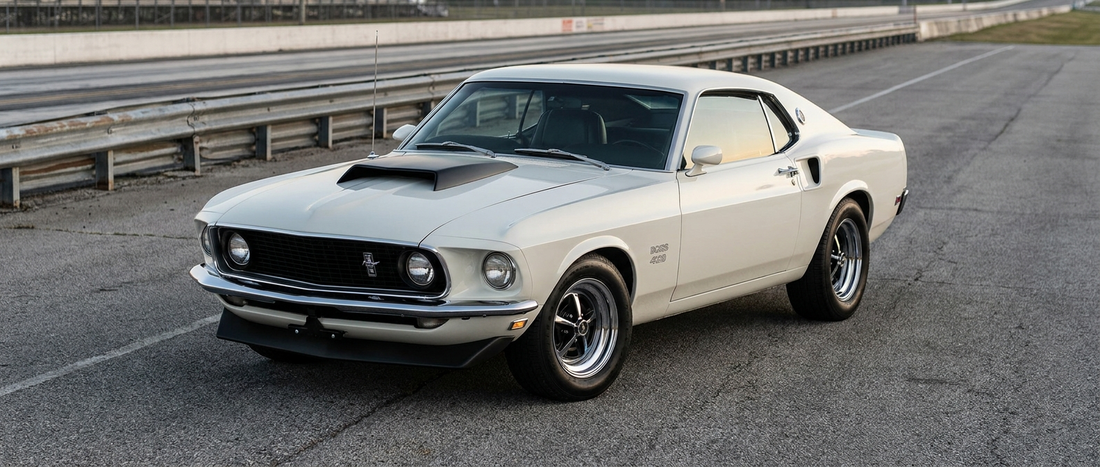 White 1969 Mustang Boss 429 with its functional hood scoop in the drag strip staging lanes