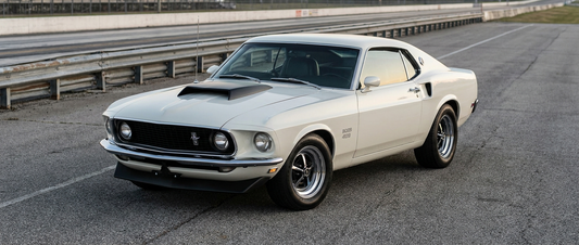White 1969 Mustang Boss 429 with its functional hood scoop in the drag strip staging lanes