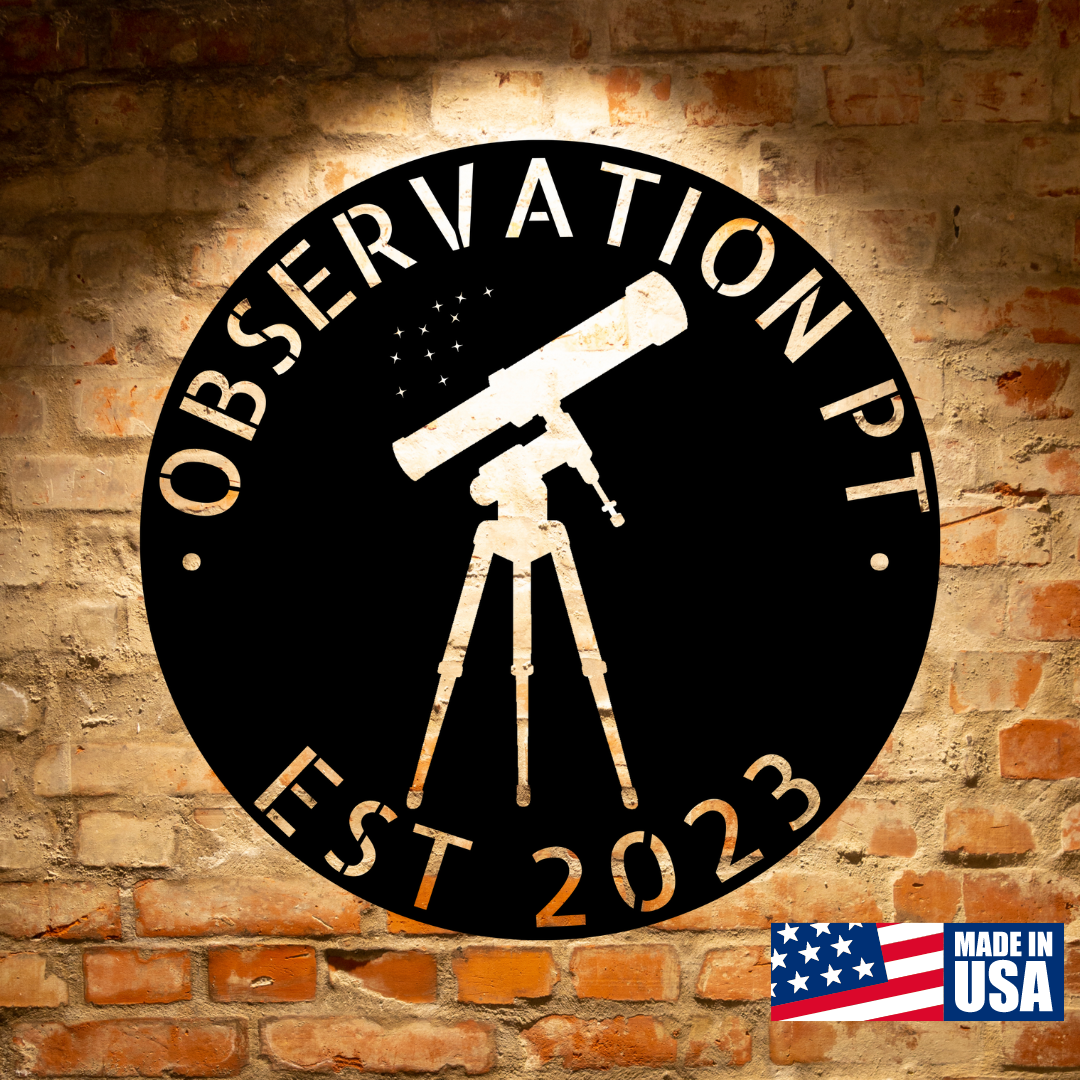 Round sign on a brick wall with a telescope and "OBSERVATION PT EST 2023" text. "MADE IN USA" label with flag in the bottom right corner.