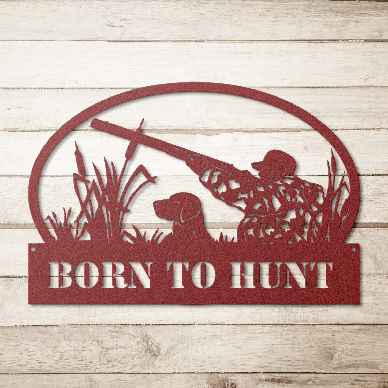 Metal sign depicting a hunter with a gun and a dog in a field, with the text "Born to Hunt" at the bottom.