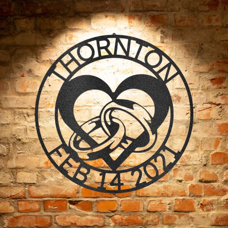 A heart shaped metal sign with the name thornton on it.