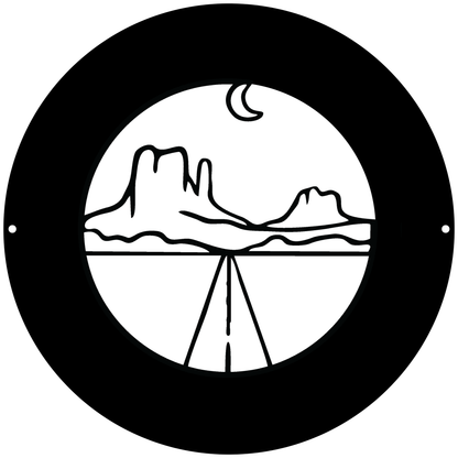 a black and white circle with a mountain in the background