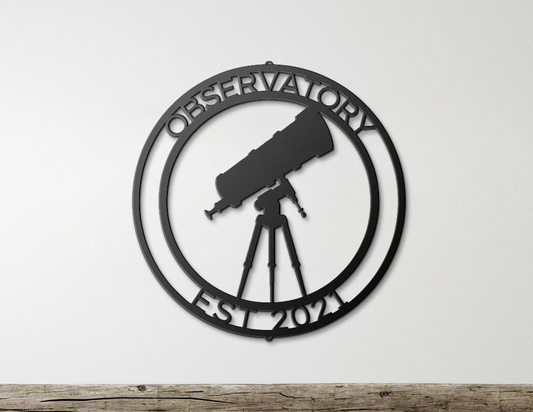 a metal sign with a telescope on top of it