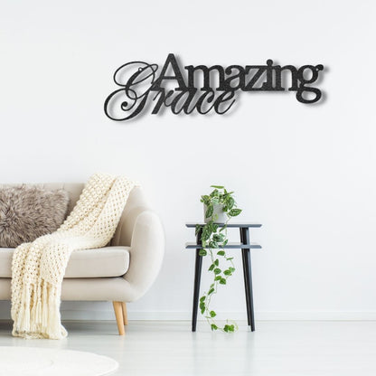 A custom handcrafted steel sign displaying "Amazing Grace" on a brick wall.