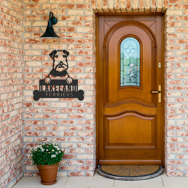 A wooden door with a Custom Pet Wall Art: Personalized Lakeland Terrier Dog Name Sign for Dog Lovers on it and a potted plant.