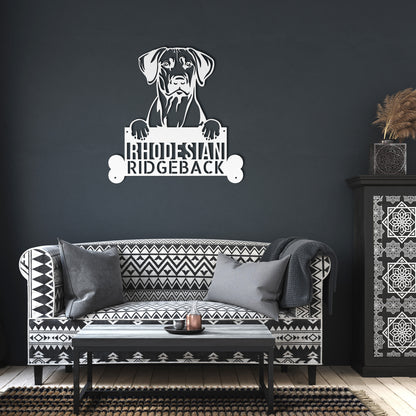 Silhouette of a Rhodesian Ridgeback dog holding a sign with the text "Rhodesian Ridgeback" and two bone shapes on both ends, perfect for a Rhodesian Ridgeback Dog Sign - Custom Metal Artwork for Animal Lover's Home, Perfect Gift.