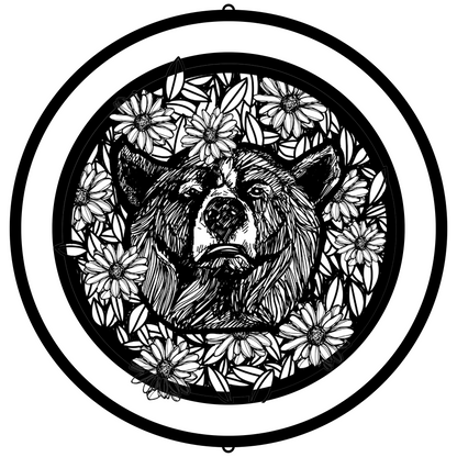 a black and white drawing of a bear surrounded by flowers