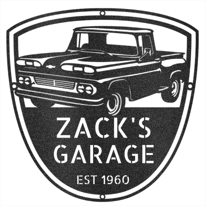 Two people hold a personalized 1960 Chevy C10 Metal Garage Sign with "GEORGE'S GARAGE EST 1967" in a field at sunset, hay bales and vintage truck decor in the background—a perfect gift for Dad or collectors.