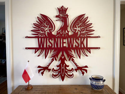 Polish eagle metal sign in red on an entry wall beside a Polish flag and Boleslawiec pottery, WISNIEWSKI