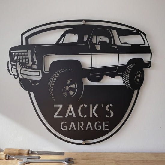 Personalized 1973 K5 Blazer front view metal sign video: the laser-cut steel badge with his name, hung on the garage wall