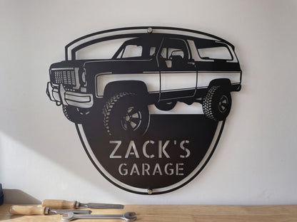 Personalized 1973 K5 Blazer front view metal sign video: the laser-cut steel badge with his name, hung on the garage wall