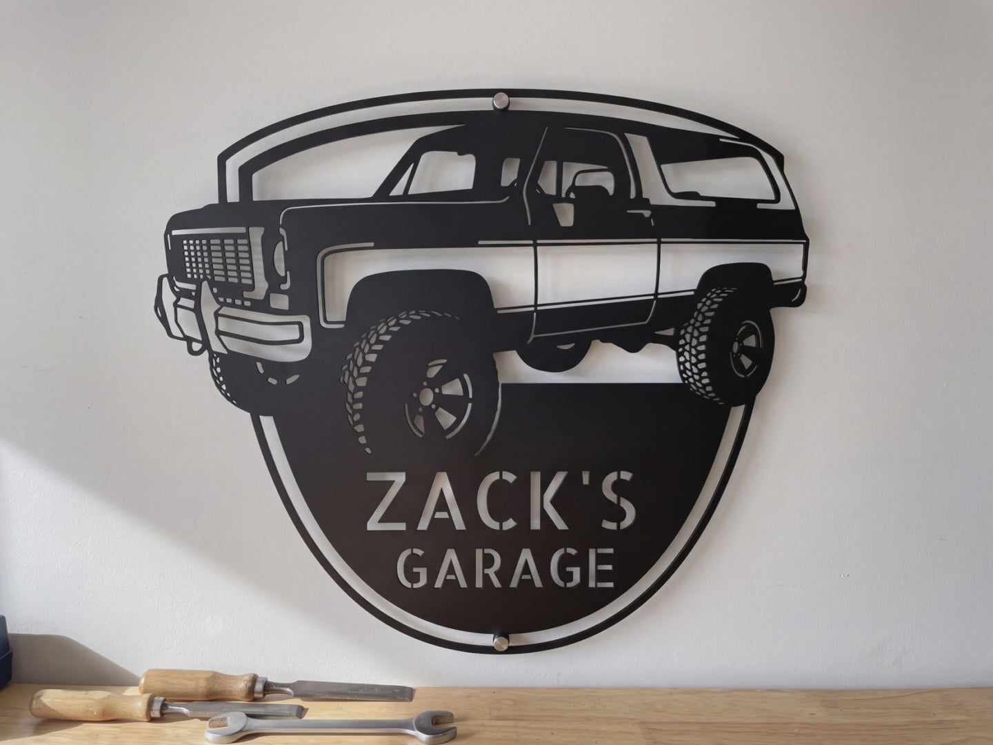 Personalized 1973 K5 Blazer front view metal sign video: the laser-cut steel badge with his name, hung on the garage wall