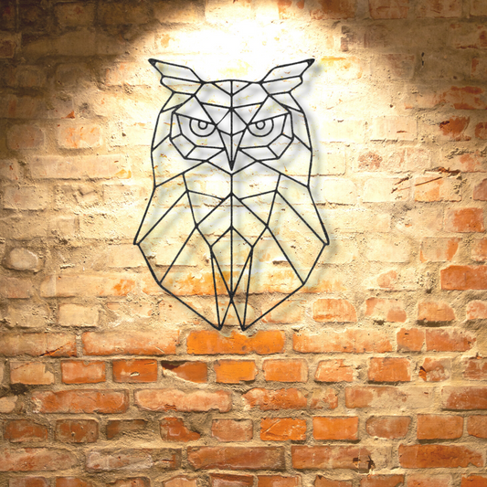 A Geometric Owl Metal Wall Art on a brick wall, perfect as a unique metal art gift.