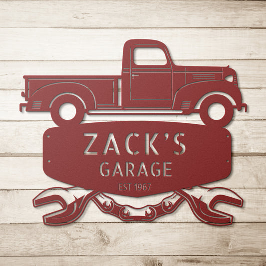 Custom steel monogram garage sign showcasing a vintage truck, personalized with "Zack's Garage" and "Est. 1967," placed above crossed wrenches on a wooden backdrop. Ideal for enthusiasts of iconic vehicles such as the 1941 Dodge WC Pickup.