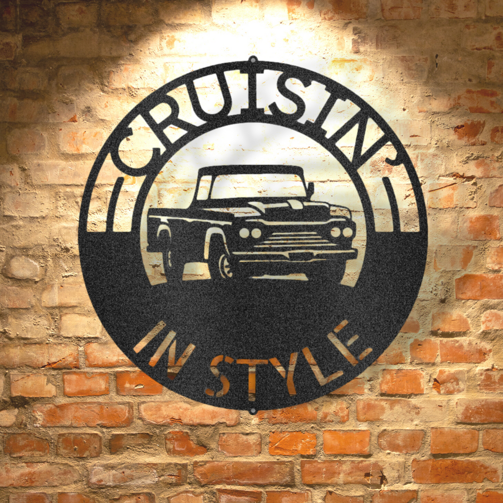 A retro steel sign featuring a classic pickup truck monogram displayed on a brick wall.