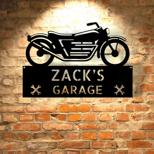 A Steel Garage Decor with the words zac's garage hanging on a brick wall.