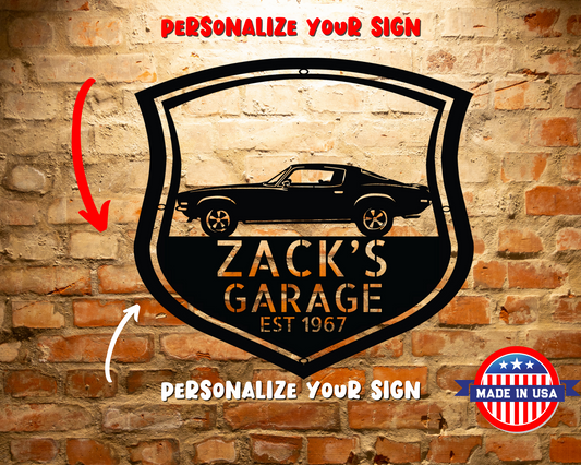 A Vintage Car Monogram Sign with Custom Car Steel Sign features, hanging on a brick wall, makes for a classic addition to any workshop or garage.