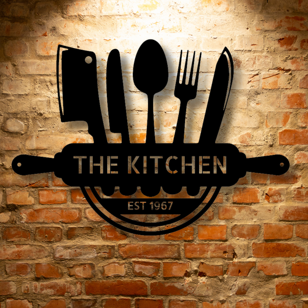 The Kitchen Monogram - Steel Sign logo on a brick wall, showcasing personalized steel monogram and unique metal art gifts.