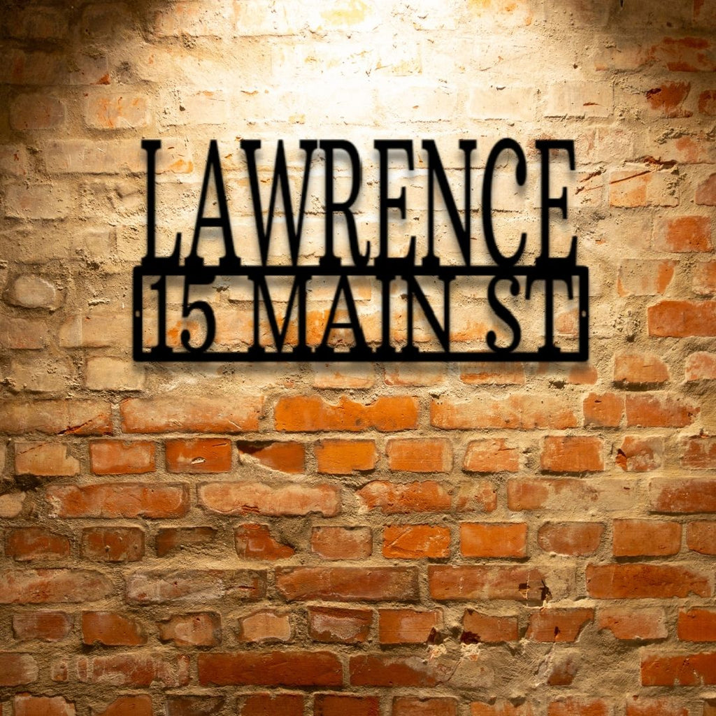 A Custom Handmade Personalized Steel Monogram Address Sign featuring the address lawrence 15 main st on a brick wall.