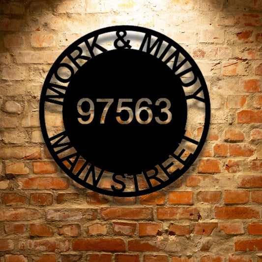 A PERSONALIZED Durable Outdoor Metal Circle Address Sign - Steel Sign that says work and maddie on a brick wall.