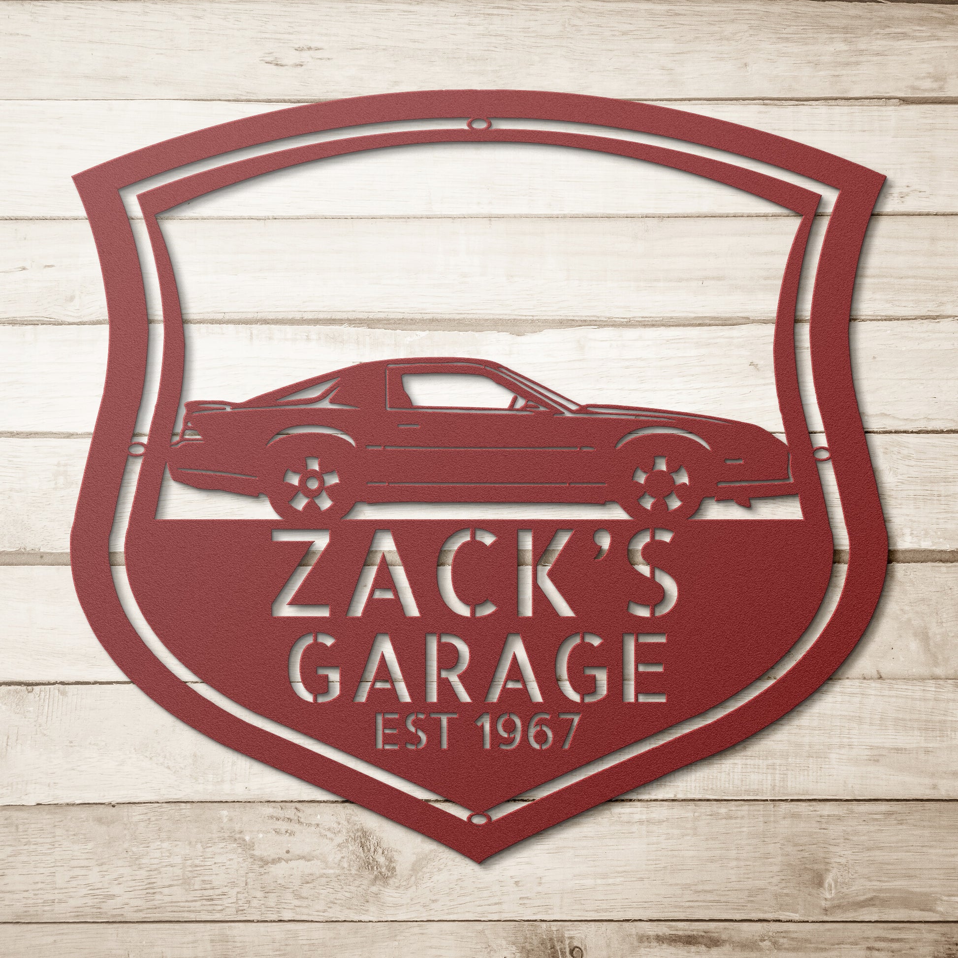 A Vintage Car Monogram Sign, personalized for a Chevrolet Camaro 1982 car enthusiast, displayed on a brick wall.