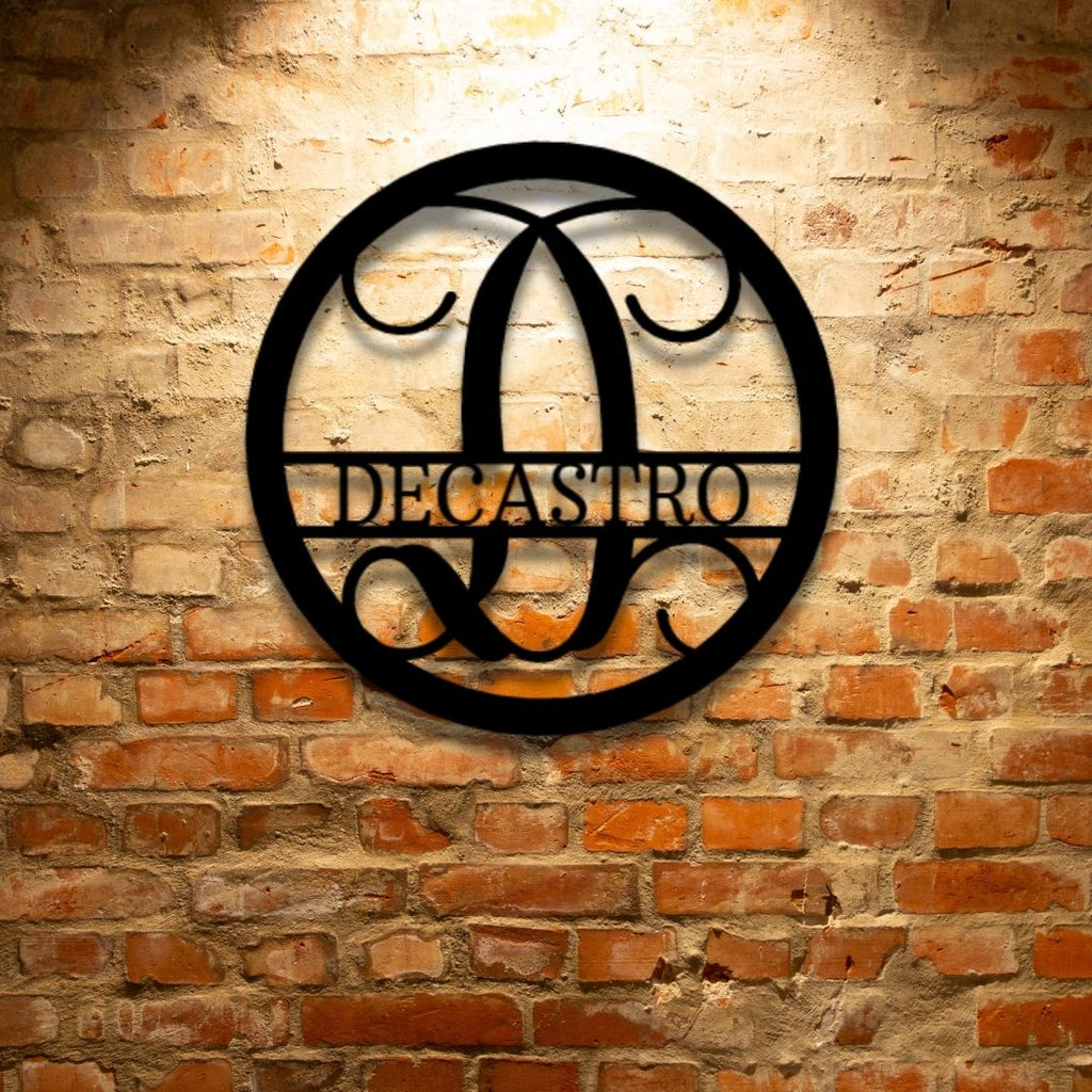 A PERSONALIZED Circle Vine Monogram - Steel Sign with the name decastro hanging on a brick wall as Metal Wall Art Decor