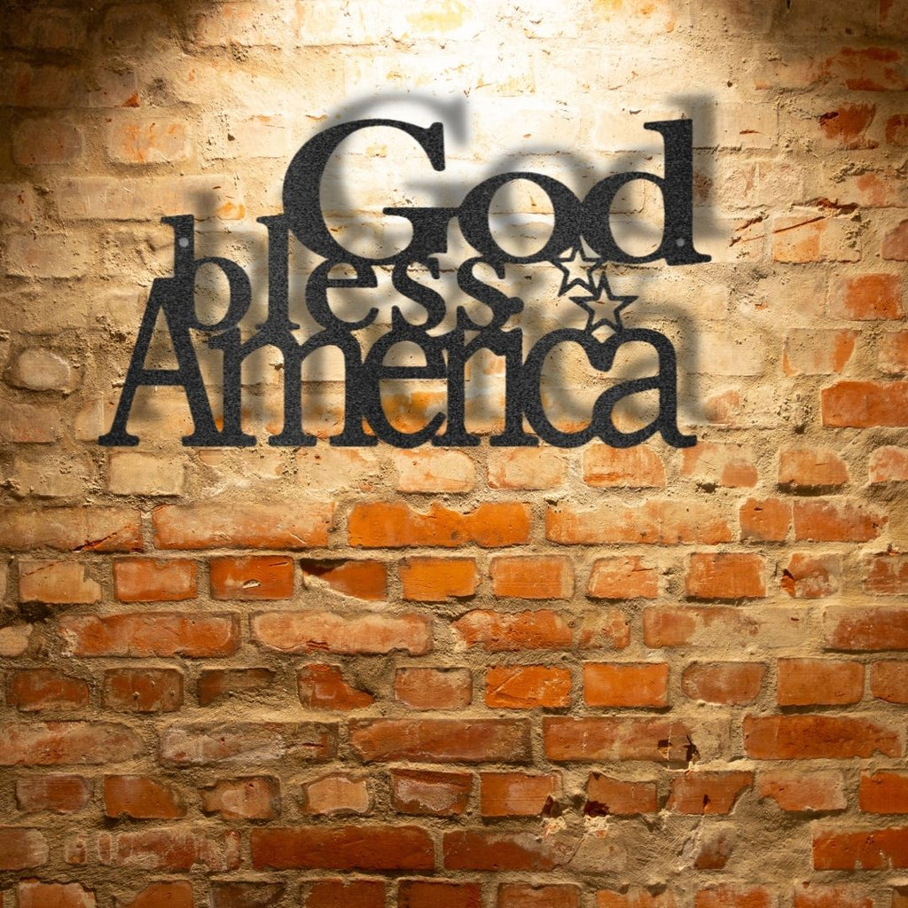 A unique metal art gift featuring a custom handmade design of the God Bless America-Steel Sign mounted on a brick wall.