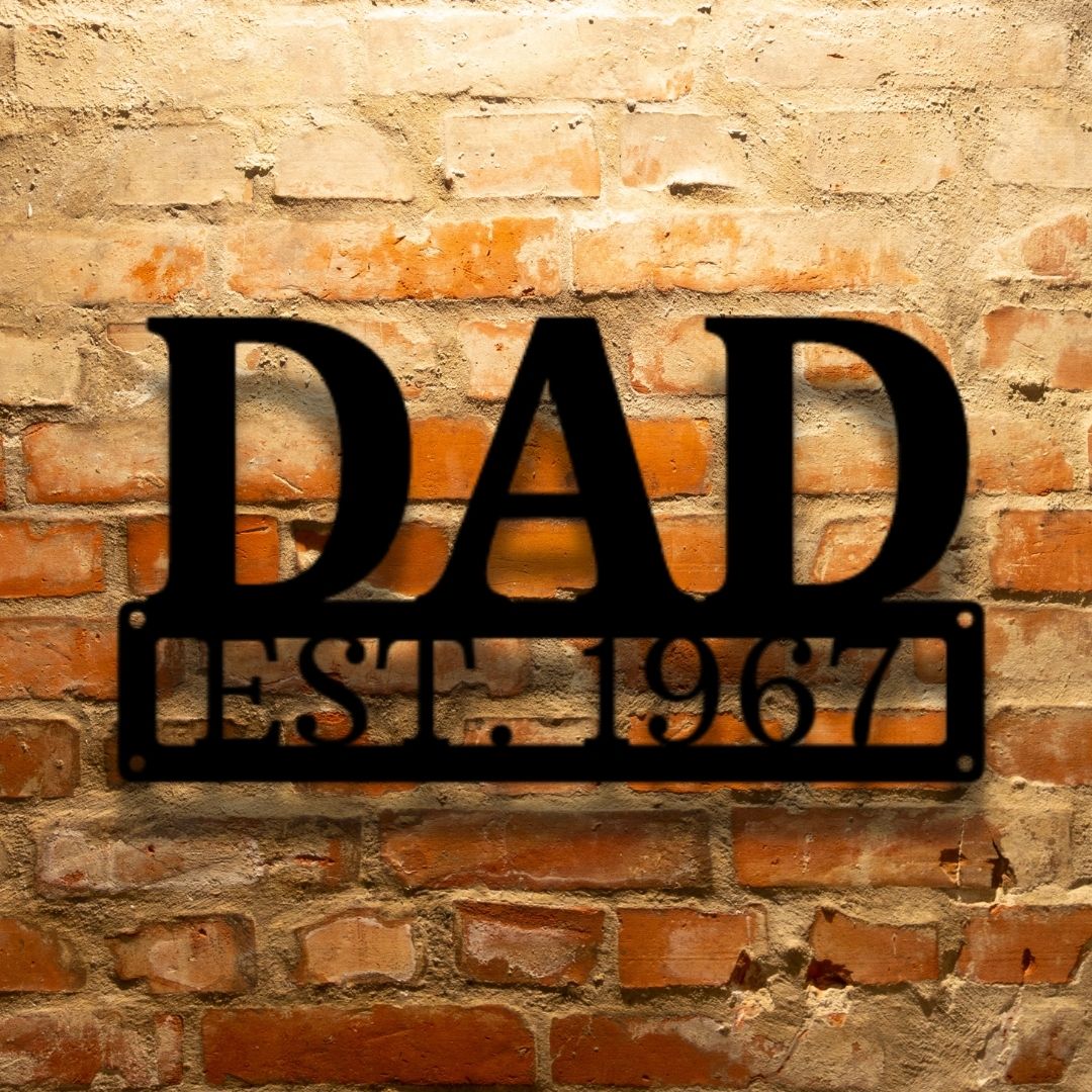 A PERSONALIZED Dad Monogram - Durable Outdoor Metal Sign with the word dad on it against a brick wall.