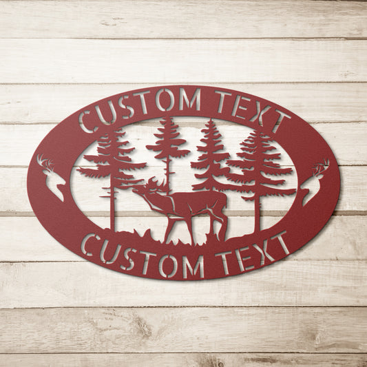 The DEER FAMILY SIGN - Customized Deer in Forest Steel Monogram Home Decor is an 18 gauge steel oval sign, showcasing a cutout design with a deer, trees, and two deer heads. It includes the option for "Custom Text" both above and below the scene. This wall decor is beautifully mounted on a wooden wall.