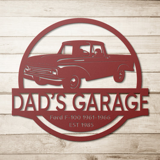 The "PERSONALIZE CAR SIGN - Ford F-100 1961-1966 Car Garage Steel Monogram" showcases a red vintage Ford truck and reads "Dad's Garage," artistically displayed on a wooden background, making it an ideal addition for interior design decor.