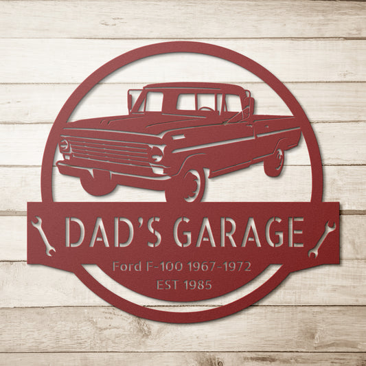 Featuring a personalized design, the CAR GARAGE SIGN - Personalized Car Ford F-100 1967-1972 Steel Monogram is crafted from 18-gauge steel and showcases a red depiction of a Ford F-100 truck with "Dad's Garage, Ford F-100 1967-1972, EST 1985" set against an elegant wooden background.