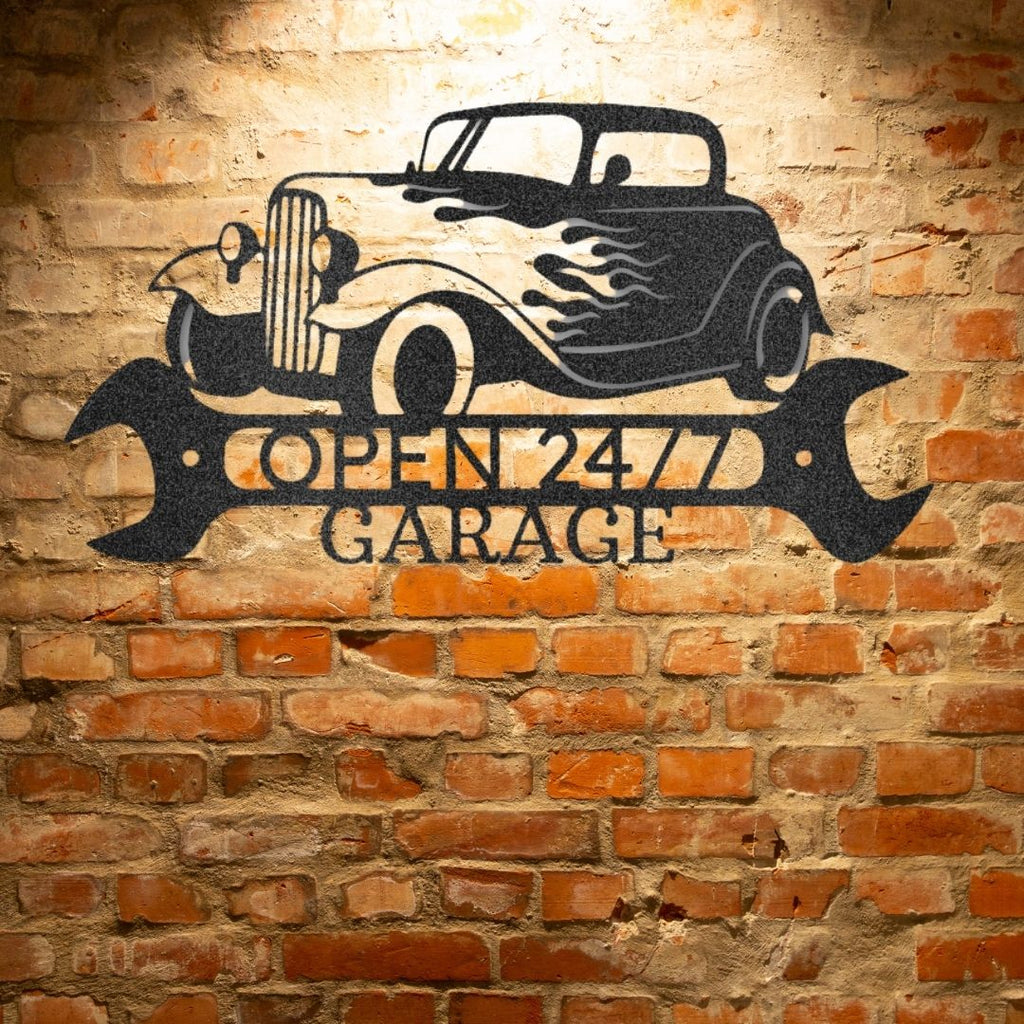A personalized steel garage sign with a retro monogram, displayed on a brick wall.