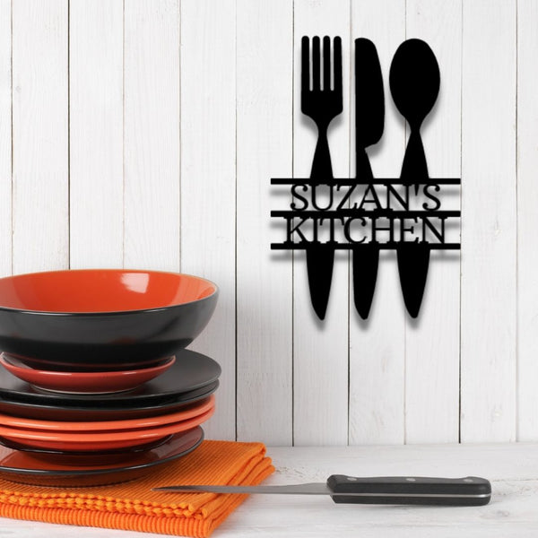 A unique, personalized Metal Wall Art Decor Monogram featuring custom handmade designs and a knife, fork, and spoon, hanging on a brick wall.