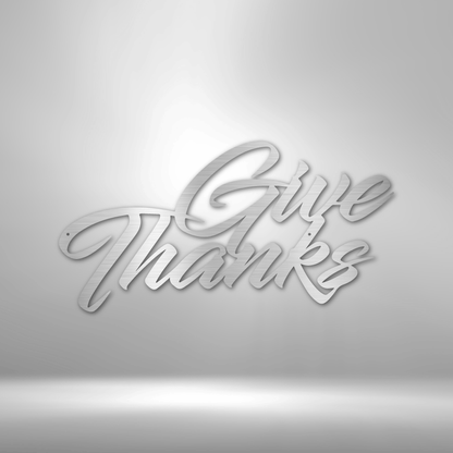 A durable metal sign displaying "Give Thanks" on a brick wall, perfect for outdoor decor.