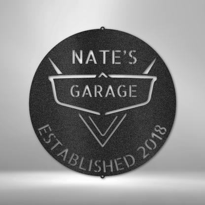 A PERSONALIZED Steel Monogram Garage Decor - Metal Wall Art that says nate's garage established 2018 on a brick wall.