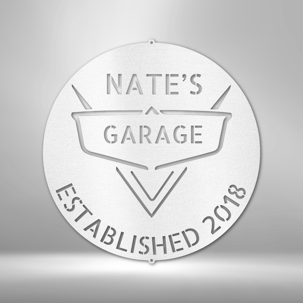 A PERSONALIZED Steel Monogram Garage Decor - Metal Wall Art that says nate's garage established 2018 on a brick wall.