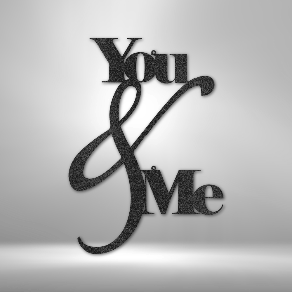 Metal Wall Art Decor - You and Me Quote on a steel sign displayed on a brick wall.