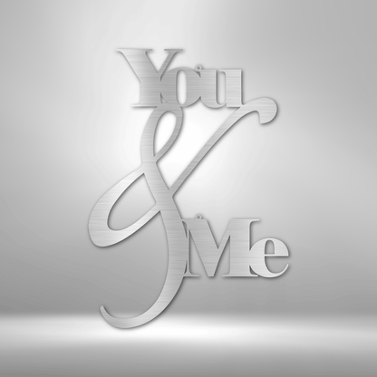 Metal Wall Art Decor - You and Me Quote on a steel sign displayed on a brick wall.