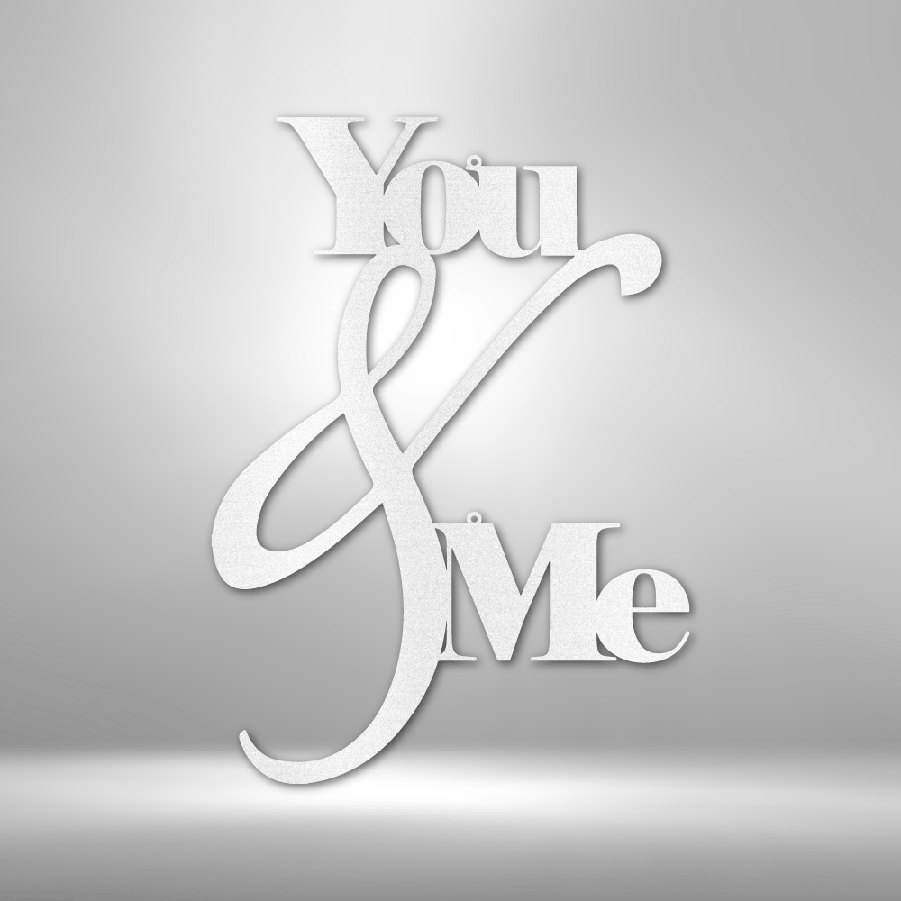 Metal Wall Art Decor - You and Me Quote on a steel sign displayed on a brick wall.