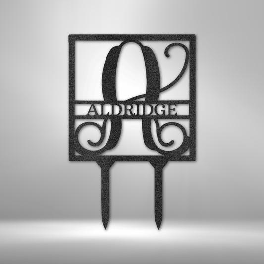 Introducing the Square Stake Monogram - Steel Sign: A laser-cut metal sign showcasing the letter "A" and the name "ALDRIDGE" in a decorative script. This durable piece is powder-coated and designed with two stakes at the bottom for easy mounting.