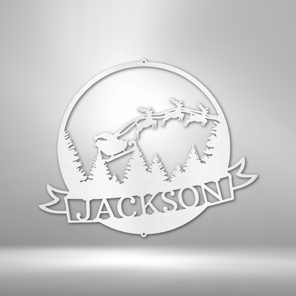 The Santa's Journey Monogram - Steel Sign showcases laser-cut artistry of Santa's sleigh and reindeer flying over pine trees, all powder-coated for durability. The piece is personalized with the name "Jackson," providing a unique addition to your holiday decor.