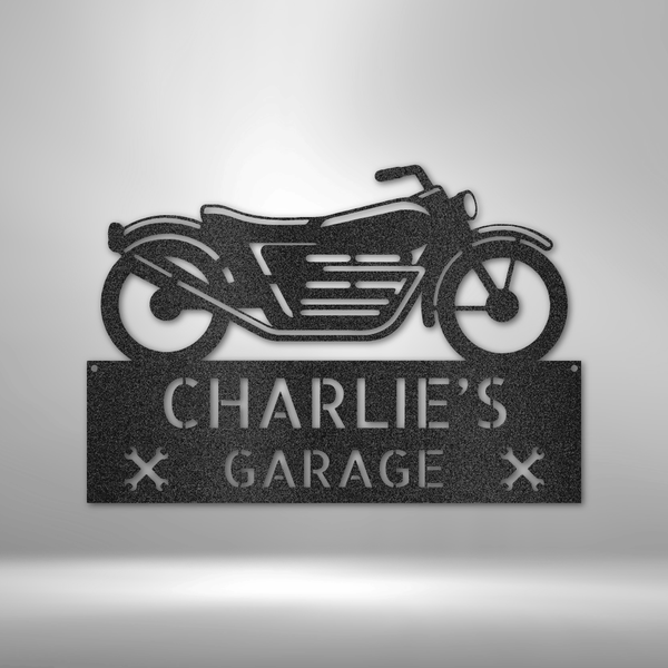 A Steel Garage Decor with the words zac's garage hanging on a brick wall.