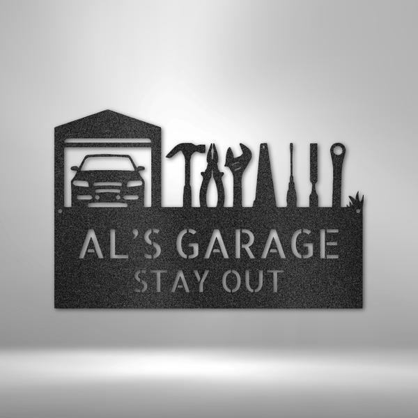 A steel sign with tools on a brick wall, showcasing retro garage decor.