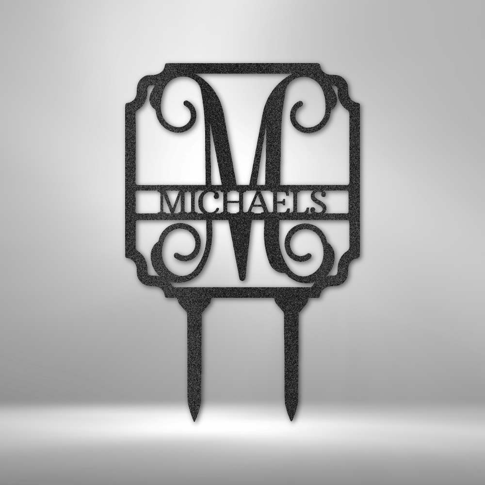 Discover the Vine Stake Monogram - Steel Sign, personalized with a large letter "M" and the word "Michaels" beneath it. This exquisite garden sign features decorative scrollwork and is expertly laser cut with a durable powder-coated finish, designed to stake seamlessly into the ground.