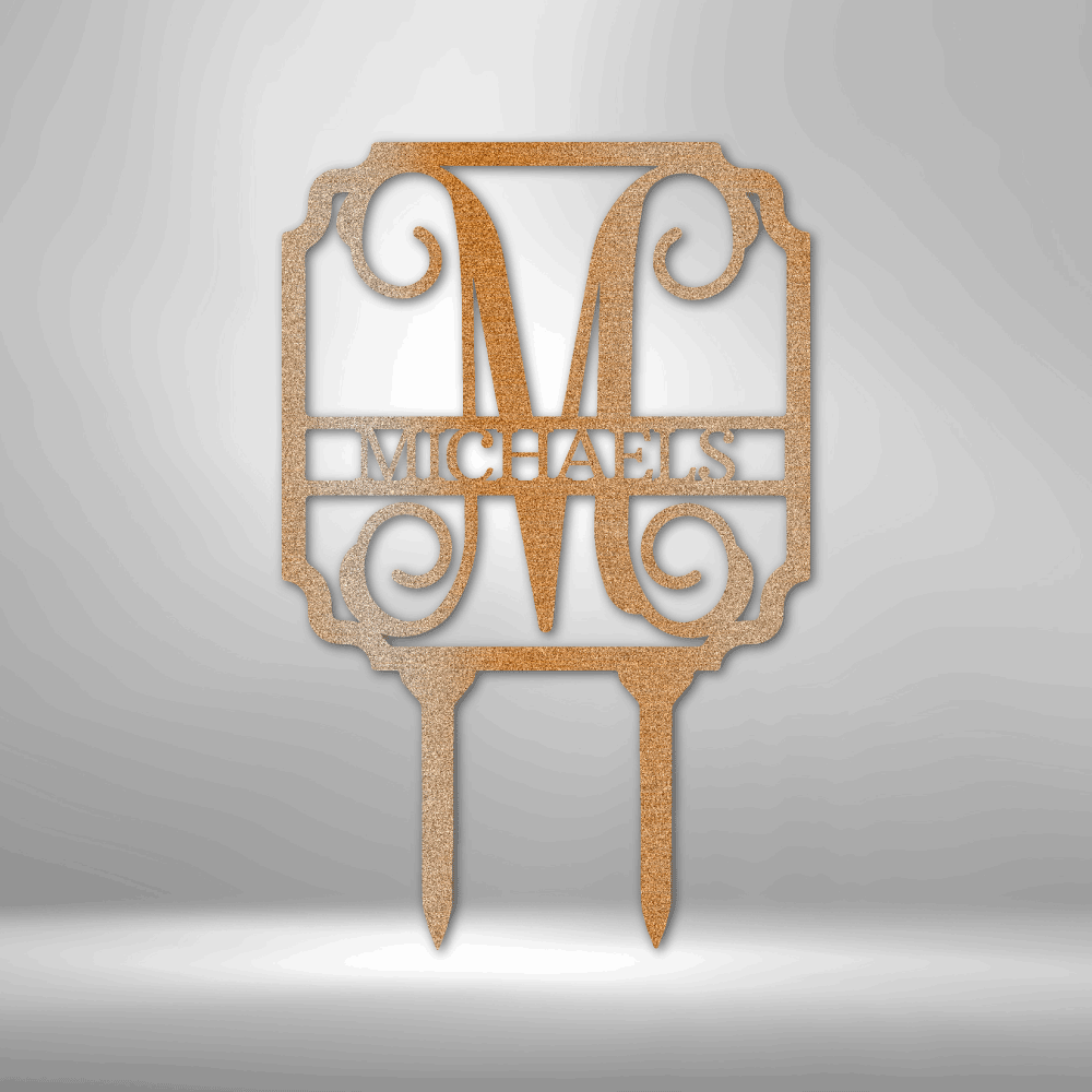 Discover the Vine Stake Monogram - Steel Sign, personalized with a large letter "M" and the word "Michaels" beneath it. This exquisite garden sign features decorative scrollwork and is expertly laser cut with a durable powder-coated finish, designed to stake seamlessly into the ground.