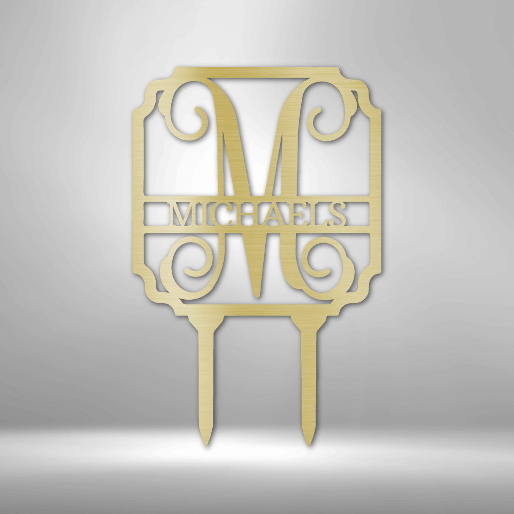 Discover the Vine Stake Monogram - Steel Sign, personalized with a large letter "M" and the word "Michaels" beneath it. This exquisite garden sign features decorative scrollwork and is expertly laser cut with a durable powder-coated finish, designed to stake seamlessly into the ground.